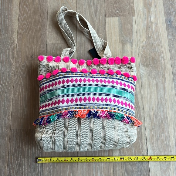 NWT. Pom Pom boho style tote. Lined w/ zip pocket & snap closure. Bright colors. - Picture 2 of 7
